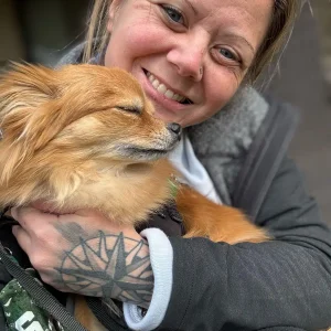Home & Pet Guardian Nicole and a long haired chihuahua nuzzling her chin. Howell, MI