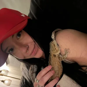 Paige Czajkowski, a Home and Pet Guardian and her bearded dragon.