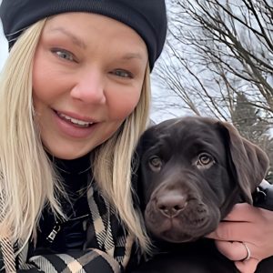 Pet Care Specialist, Kimberly Reid, and her chocolate lab puppy.